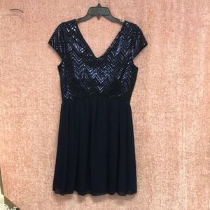 Sparkling navy blue mini dress with v neck.